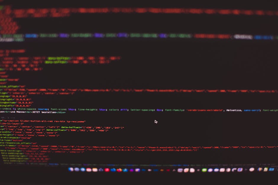 A close-up view of a computer screen displaying colorful lines of HTML and CSS code, featuring red, green, blue, and purple text on a predominantly black background. The code appears to be part of a w